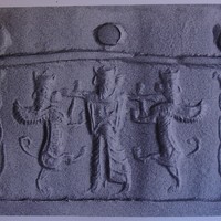 Stamp-cylinder seal: Royal hero grasping human-headed winged lion (lamassu, sphinx) on either side (cylinder image) – Head of Bes (stamp image)