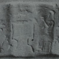 Bearded figure sitting on stool at table