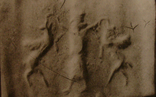 Royal hero grasping winged wild goat (ibex) on either side