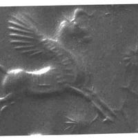Winged bull galloping towards bush